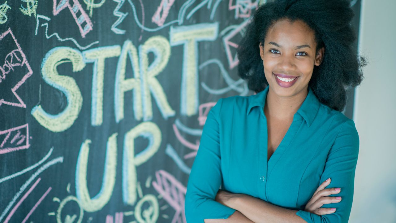 an entrepreneur standing by a start up sign | Scott Legal, P.C. an entrepreneur standing by a start up sign