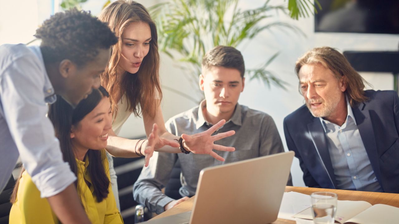 A teacher and mentor with a group of students | Scott Legal, P.C. A teacher and mentor with a group of students