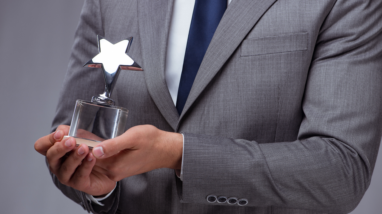 A professional holding an award | Scott Legal, P.C. A professional holding an award