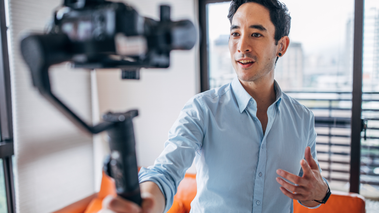An influencer with a video camera recording himself | Scott Legal, P.C. An influencer with a video camera recording himself