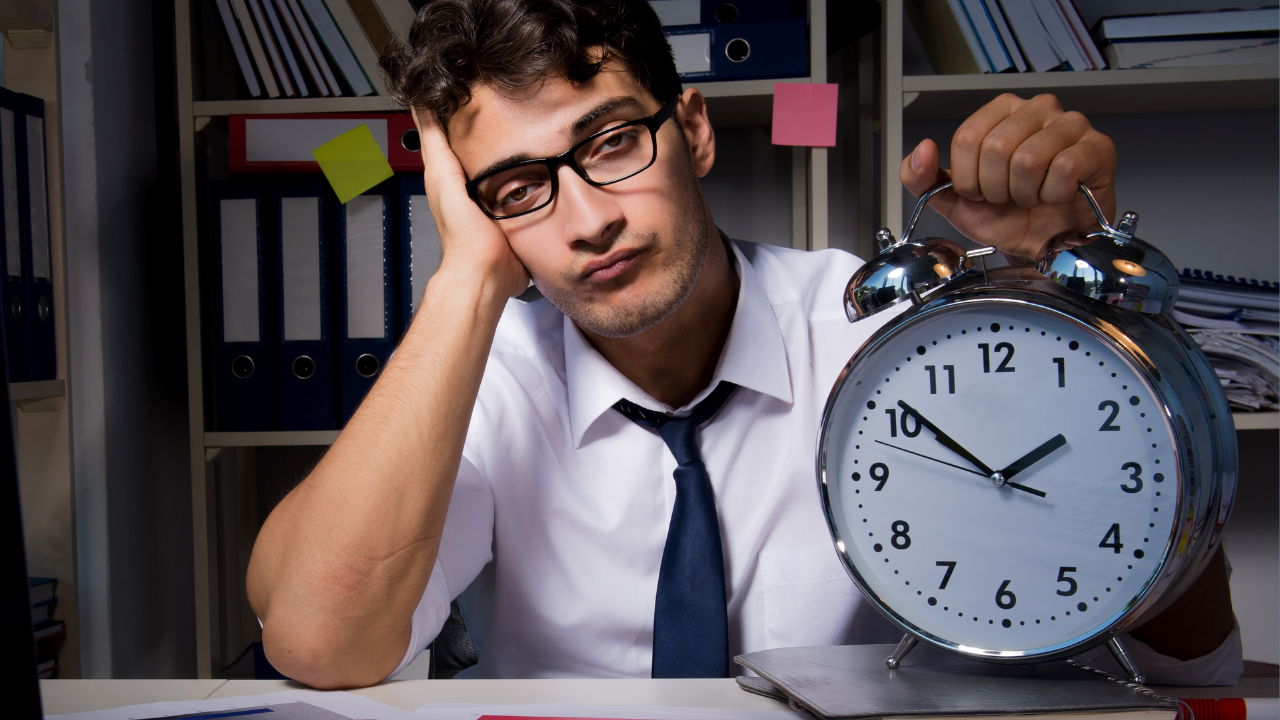 A man holding a clock to demonstrate delays | Scott Legal, P.C. A man holding a clock to demonstrate delays