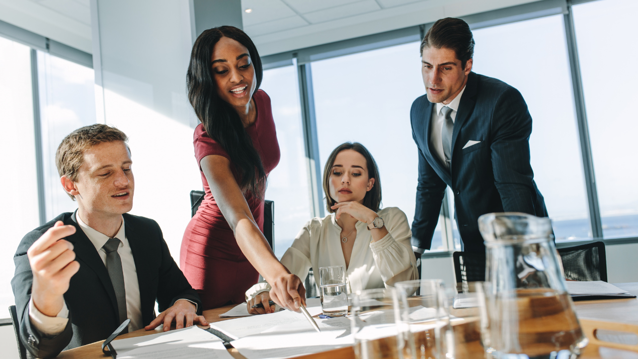 A team of skilled professionals gathered around a table | Scott Legal, P.C. A team of skilled professionals gathered around a table