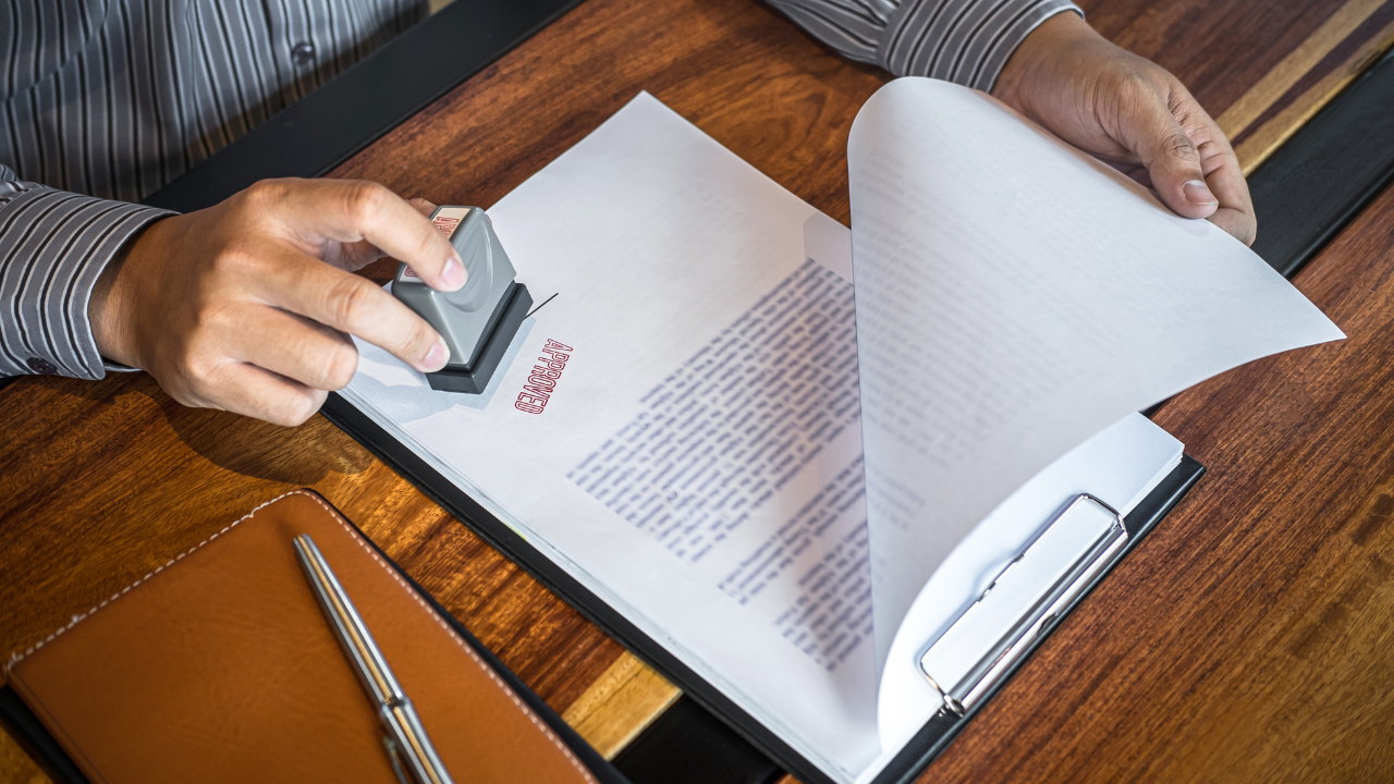 An approval stamp on a document | Scott Legal, P.C. An approval stamp on a document