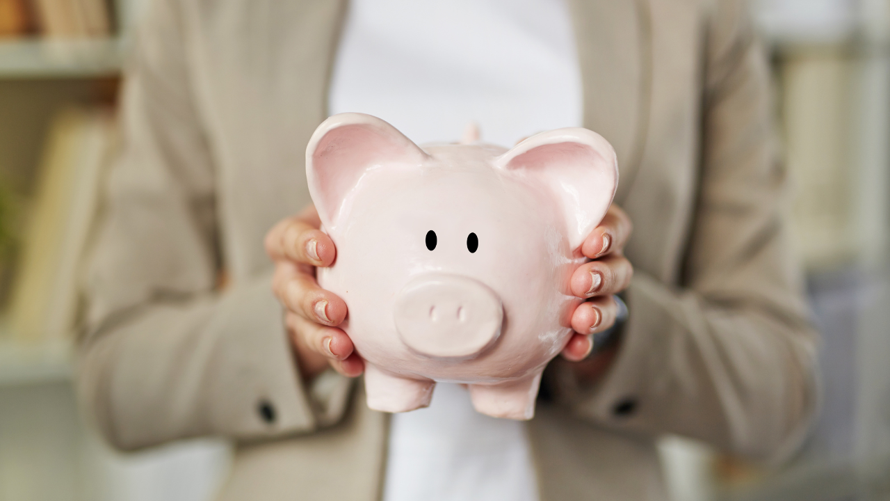 a woman holding a piggy bank | Scott Legal, P.C. a woman holding a piggy bank