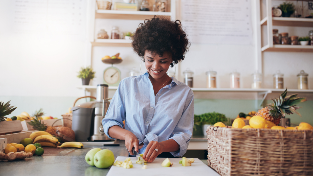 a woman working in a juice shop cutting up apples | Scott Legal, P.C. a woman working in a juice shop cutting up apples