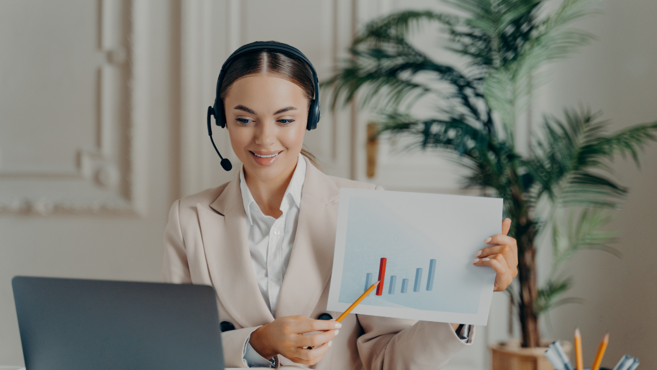 A woman on a video call holding a graph | Scott Legal, P.C. A woman on a video call holding a graph