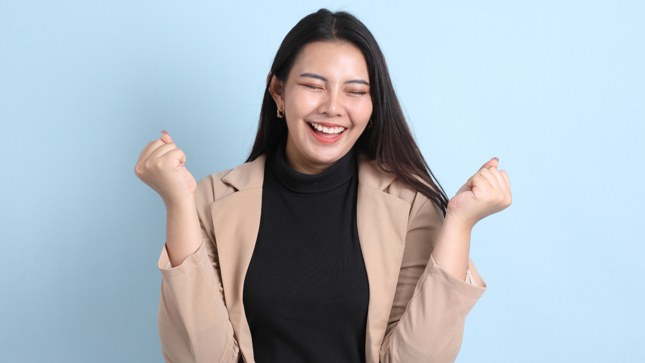 A woman celebrating a win | Scott Legal, P.C. A woman celebrating a win