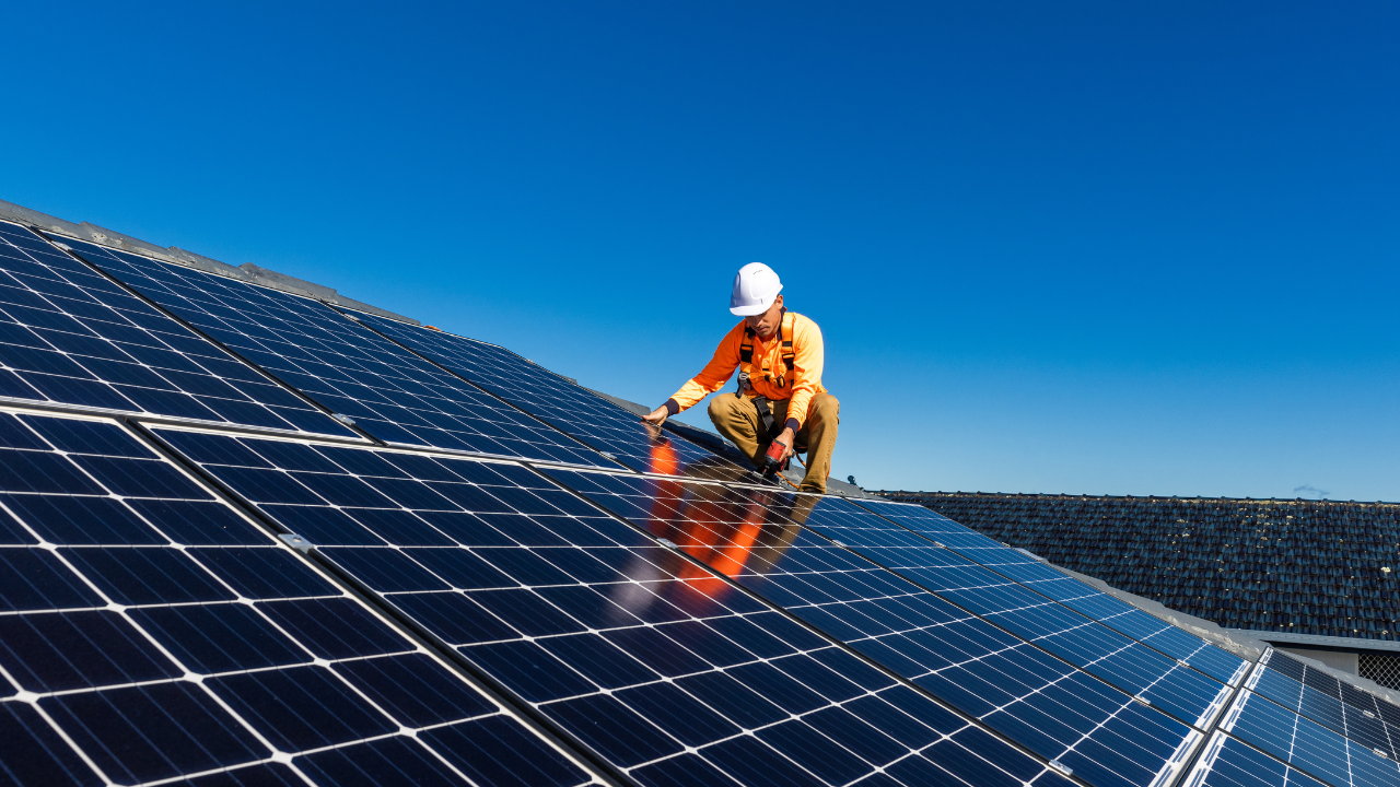 Image 2 | Scott Legal, P.C. A man installing solar panels