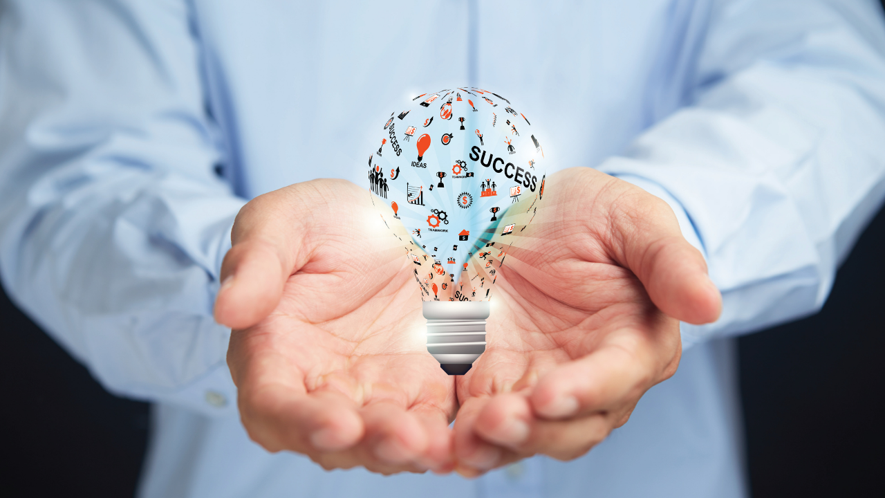 A man holding a light bulb with business success inside | Scott Legal, P.C. A man holding a light bulb with business success inside