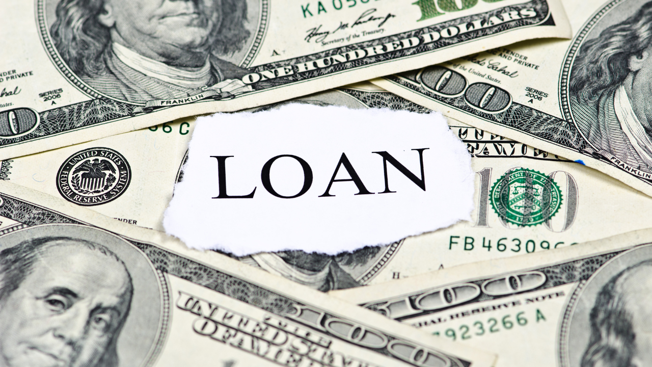 A collection of money with a note that says, "loan" | Scott Legal, P.C. A collection of money with a note that says, "loan"