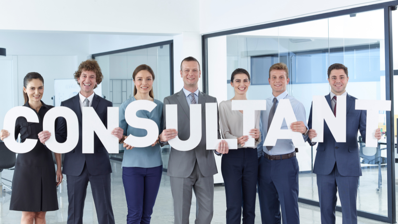 consultant sign being held by group of professionals | Scott Legal, P.C. consultant sign being held by group of professionals