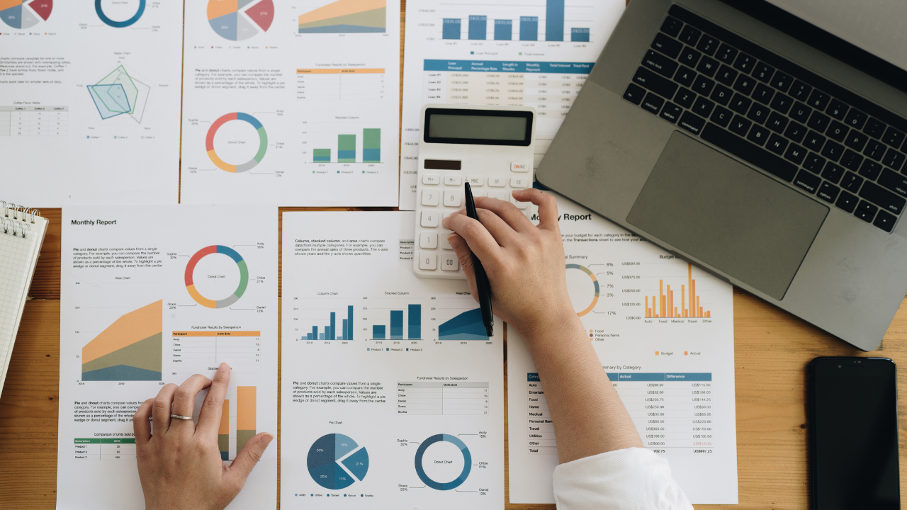 A collection of graphs and charts on a table. | Scott Legal, P.C. A collection of graphs and charts on a table.
