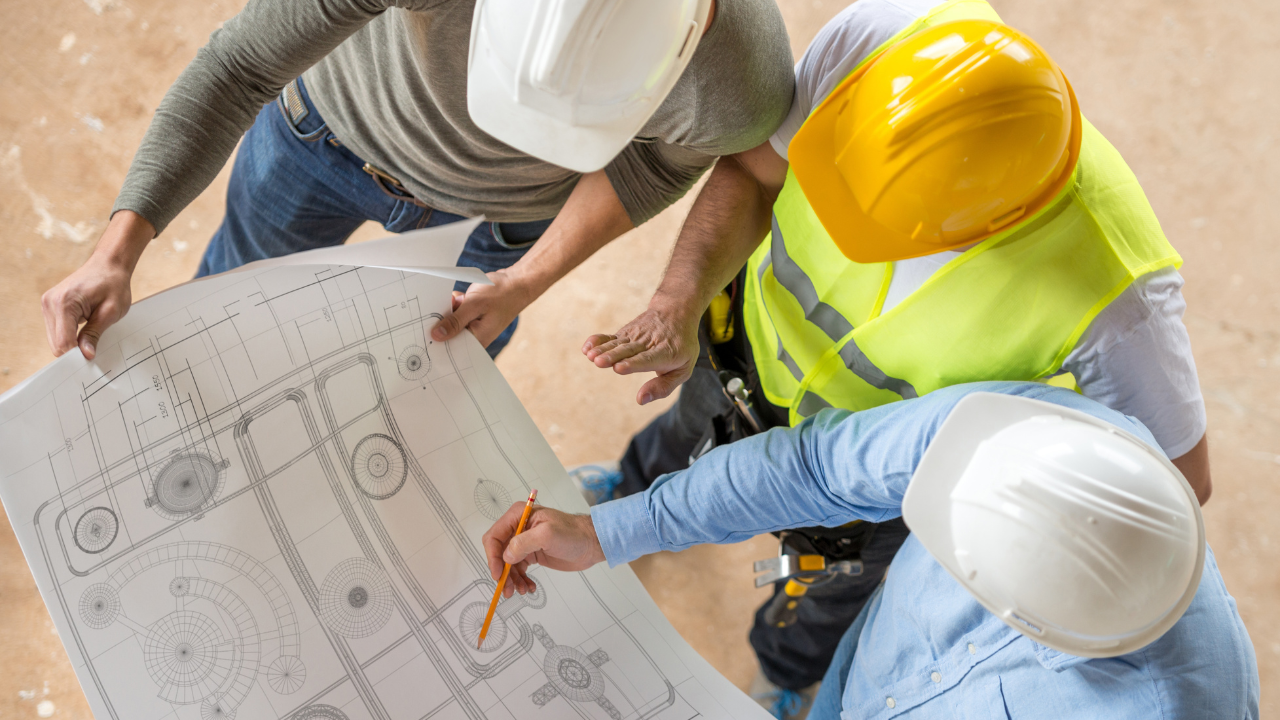3 engineers working together looking at a chart | Scott Legal, P.C. 3 engineers working together looking at a chart