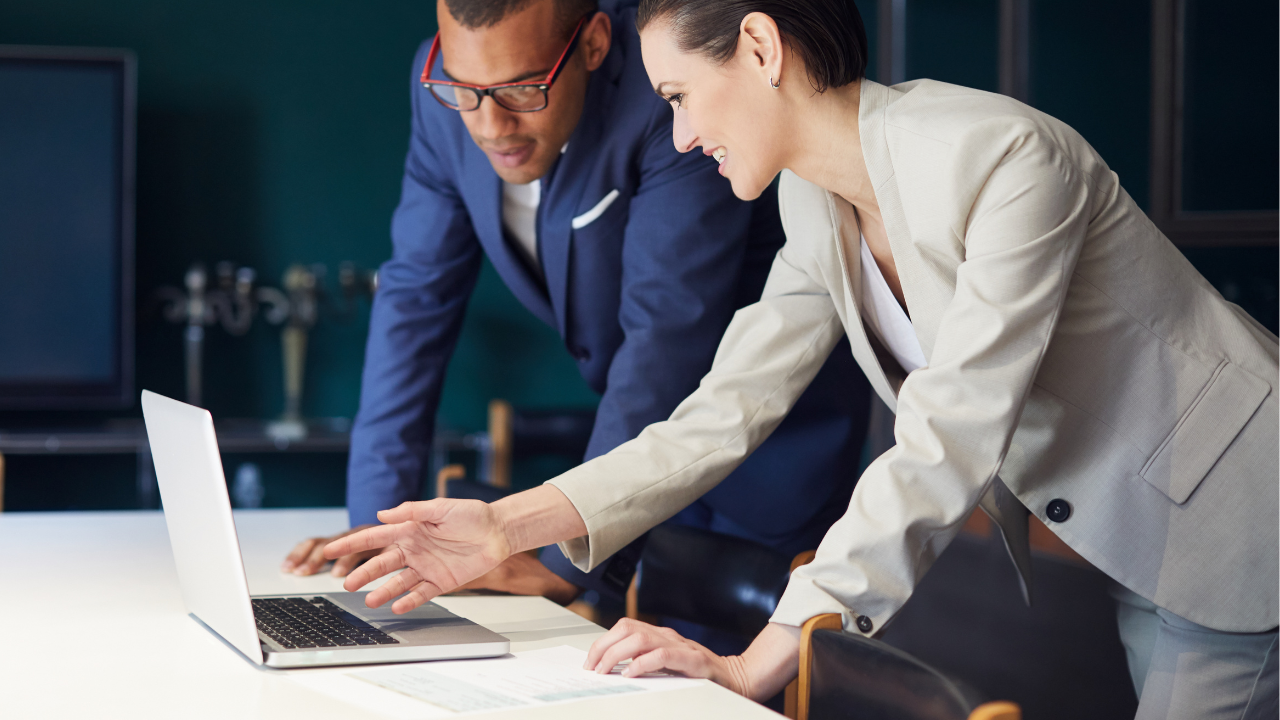 Two corporate individuals considering their options on a laptop | Scott Legal, P.C. Two corporate individuals considering their options on a laptop