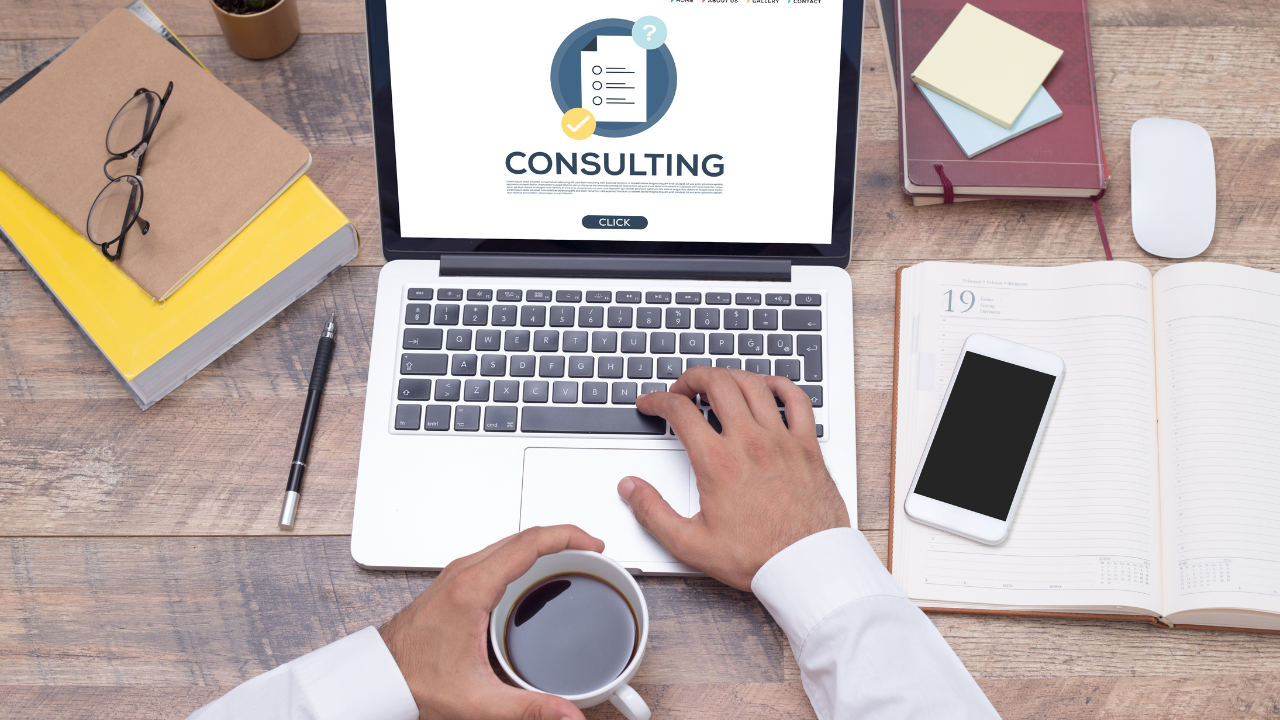Management Consultant reviewing consulting notes on laptop | Scott Legal, P.C. Management Consultant reviewing consulting notes on laptop