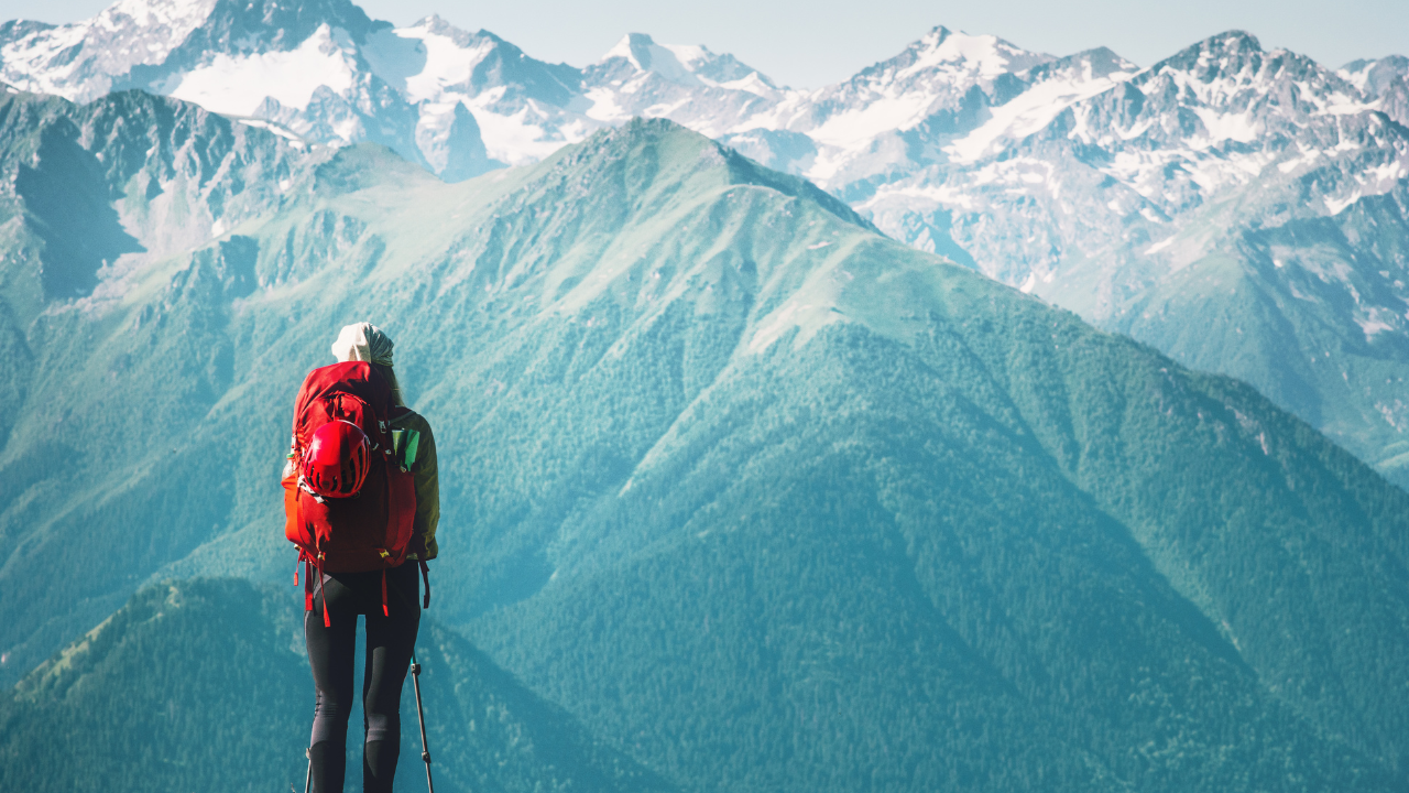 A traveler looking at the mountains ahead of her | Scott Legal, P.C. A traveler looking at the mountains ahead of her