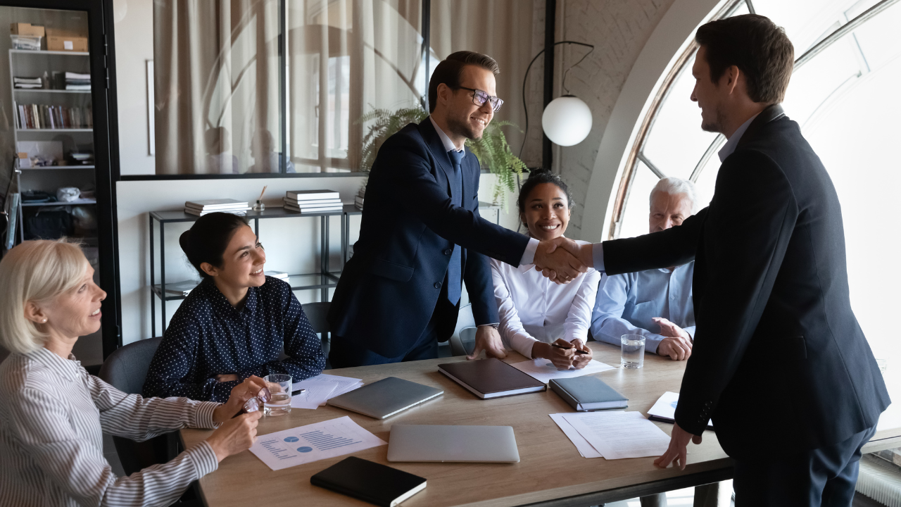 A man shaking hands with a new employer | Scott Legal, P.C. A man shaking hands with a new employer