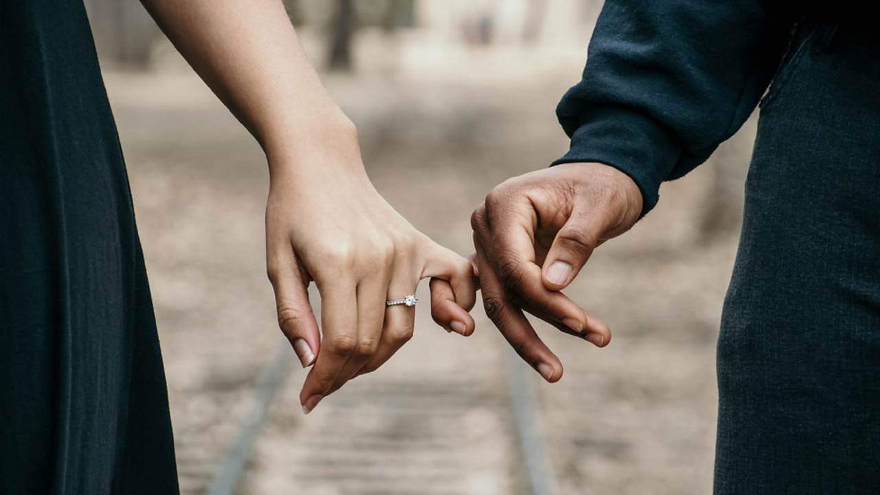 Married couple linking hands | Scott Legal, P.C. Married couple linking hands