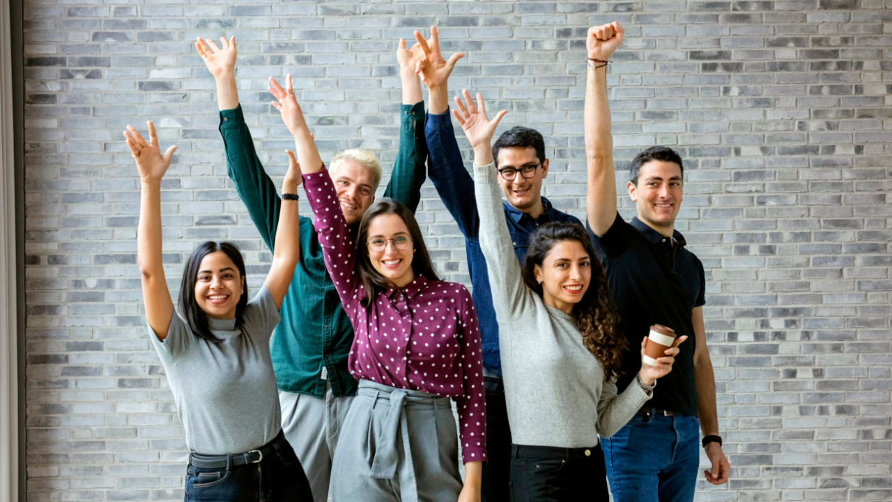 A happy business team celebrating | Scott Legal, P.C. A happy business team celebrating