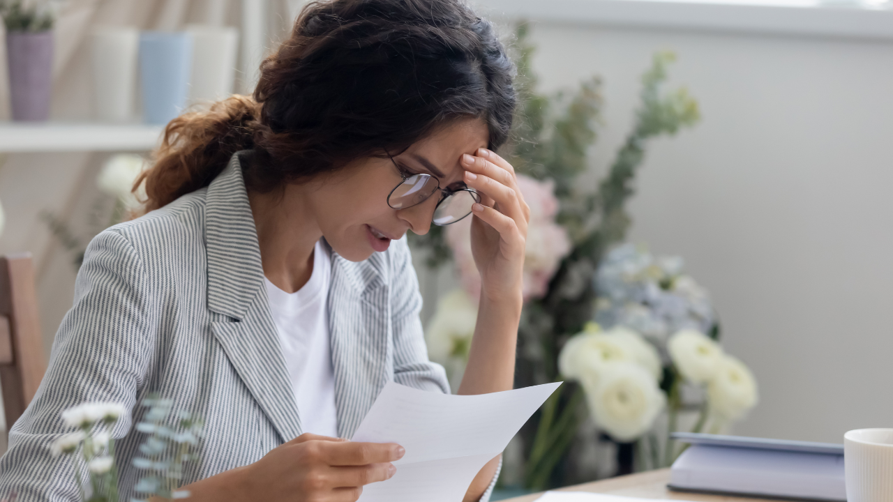 A woman reading a denial notice | Scott Legal, P.C. A woman reading a denial notice