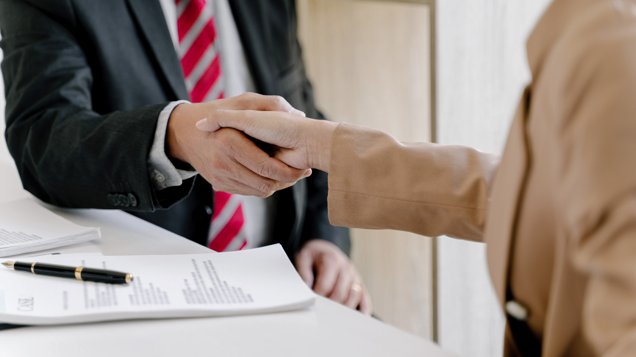 Handhsake | Scott Legal, P.C. A consultant shaking hands with a client
