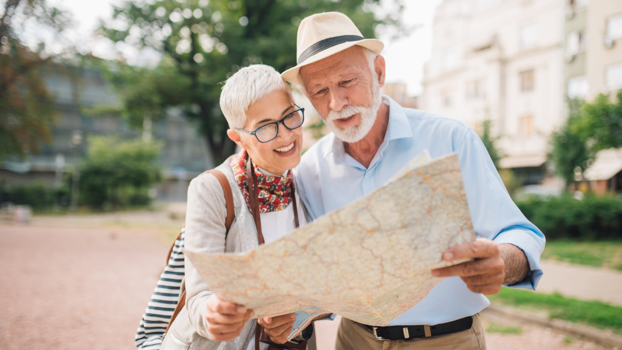 Two tourists looking at a map while travelling | Scott Legal, P.C. Two tourists looking at a map while travelling